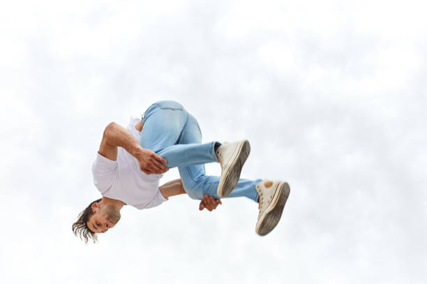 istock Fitness guy doing parkour trick while jumping in the air 1226339325