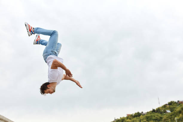 istock stuntman performing backward somersault, full length photo 1226339336