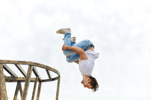 istock man hugging his legs performing a stunt upside down 1226339341
