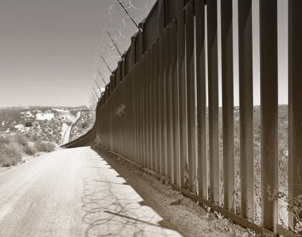 US-Mexican Border The US-Mexico border wall, at Campo, California. international border barrier stock pictures, royalty-free photos & images