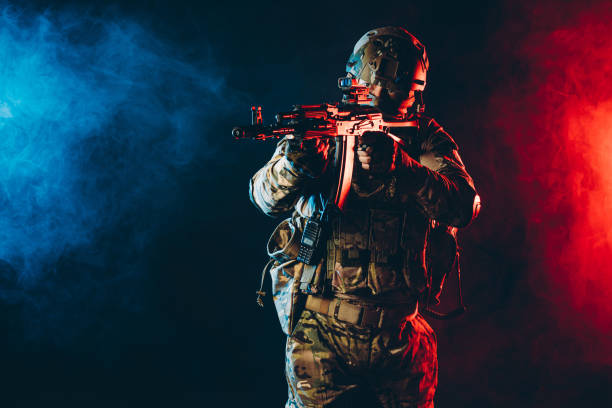 istock soldier man in uniform pointing rifle isolated over smoky space 1226341368