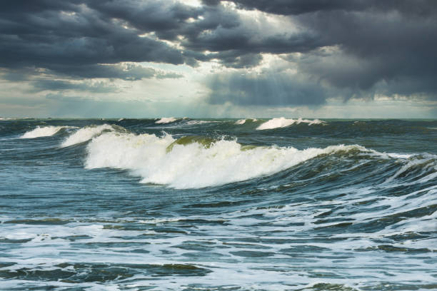 istock Surf waves seascape moody sky blue nature background 1226341454