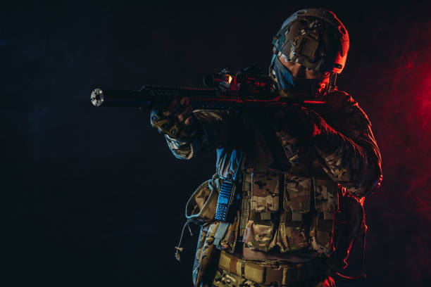 istock soldier man in uniform pointing rifle isolated over smoky space 1226342039