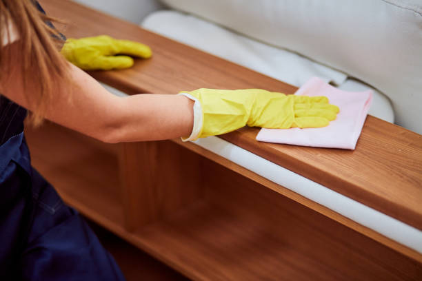 istock Female janitor hands wipig dust off from table. Cleaning concept 1226344168