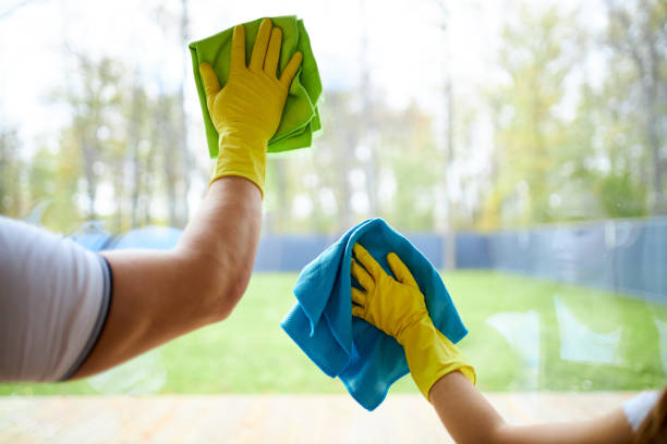 istock Closeup of janitors hands cleaning window 1226344863