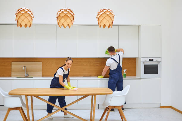 istock Two young janitors in blue uniform cleaning kitchen 1226346440