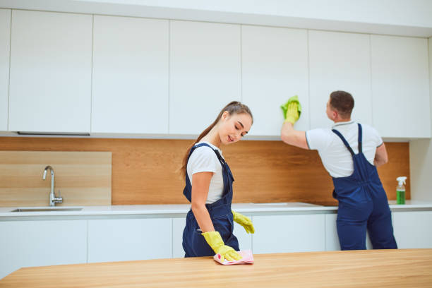 istock Hardworking cleaning service team at work in kitchen with white interior 1226346629