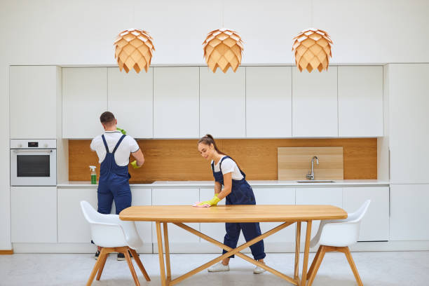 istock Two young janitors in blue uniform cleaning kitchen 1226346775