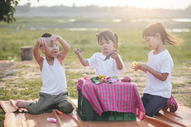 istock Asian kids makes plasticine  in park 1226349221