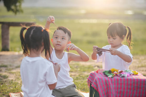 istock Asian kids makes plasticine  in park 1226349279