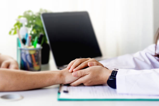 istock Doctor working in the office and holding  patient's hands. 1226350571