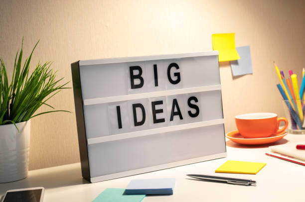 istock Business creativity with big idea text on cinema light box and worktable.inspiration and motivation.brainstorming and sharing ideas.performance of human. 1226354662