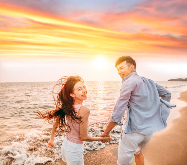 istock Romantic couple having fun on the beach at sunset 1226360466