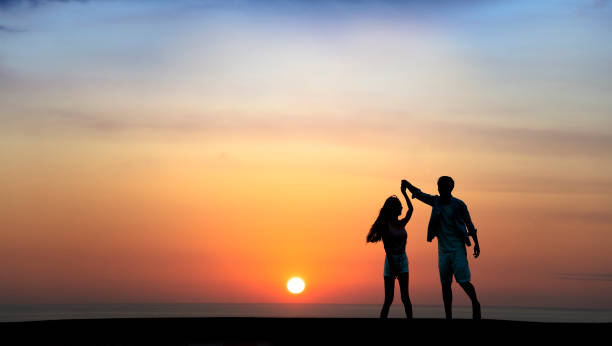 istock Happy Romantic young Couple dancing on the beach at sunset 1226360471