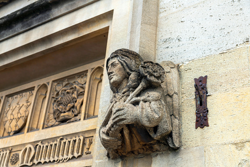 Entrance to an Oxford College with carving above the door, this is one of two busts carved each side of the door.