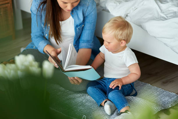 istock Mother reading book with her toddler son 1226362339