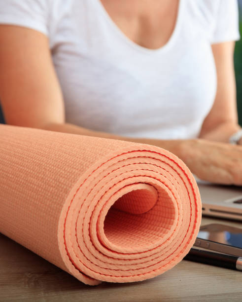 istock Woman and an exercise mat in an office background 1226362906