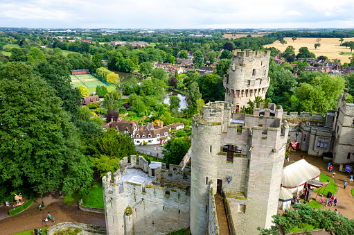 Warwick, UK - 20th May, 2018; Warwick Castle is a medieval castle originally built by William the Conqueror during 1068. Warwick is the county town of Warwickshire, England, situated on a bend of the River Avon. The original wooden castle was rebuilt in stone during the 12th century. Today it is major tourist attraction visited by people from all over the world.
