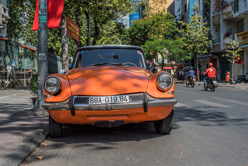 Orange Citroen DS parked in a street of Ho Chi Minh City, Vietnam