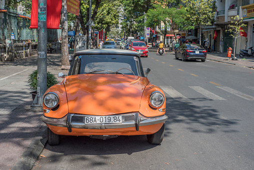 Orange Citroen DS parked in a street of Ho Chi Minh City, Vietnam