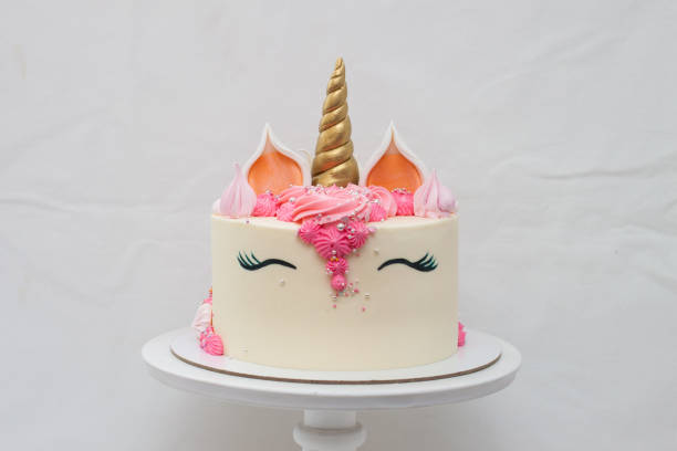 istock Homemade unicorn layered cake decorated with whipped cream. Light grey plain background. 1226363156