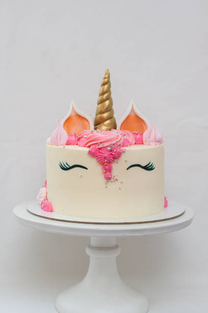 istock Homemade unicorn layered cake decorated with whipped cream. Light grey plain background. 1226363157