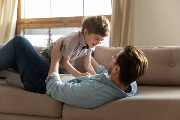 istock Happy dad and little son have fun at home 1226364342