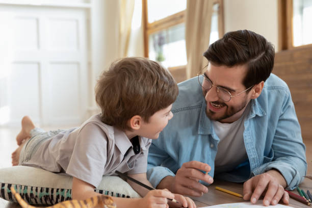 istock Loving dad drawing with cute little preschooler son 1226364352