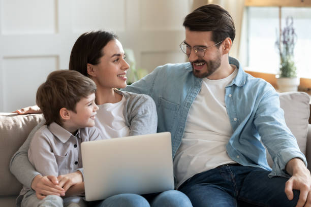istock Young family with small son using laptop at home 1226364353
