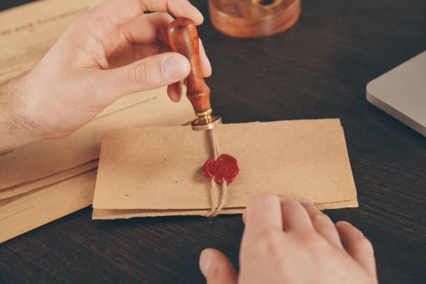 istock Male attorney stamping document. Seal on notarized paperwork. 1226366878