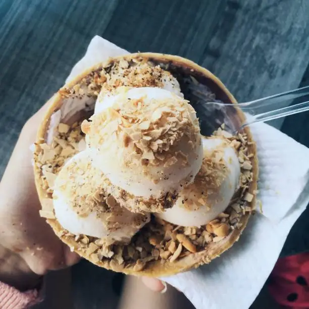 Coconut ice cream with peanut flakes