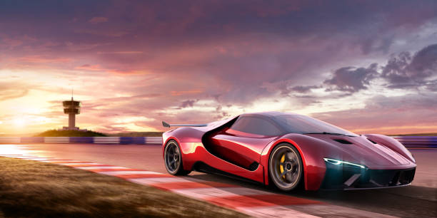 Sports Car Moving At High Speed On Racetrack At Sunset A close up image of a generic red sports car moving at high speed on a racetrack at beautiful dramatic and colourful sky at sunset. The location is fictional, and observation tower is visible in the background. Selective focus, with car in focus and motion blur on foreground. concept car photos stock pictures, royalty-free photos & images
