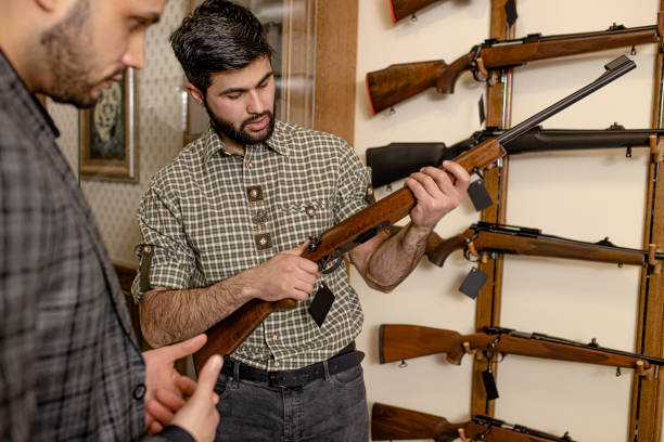istock affable salesman offer firearm to customer 1226369361