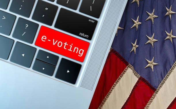 istock Electronic or internet voting concept (e-voting or online voting). Keyboard with red button with e-voting written against usa flag. 1226373079