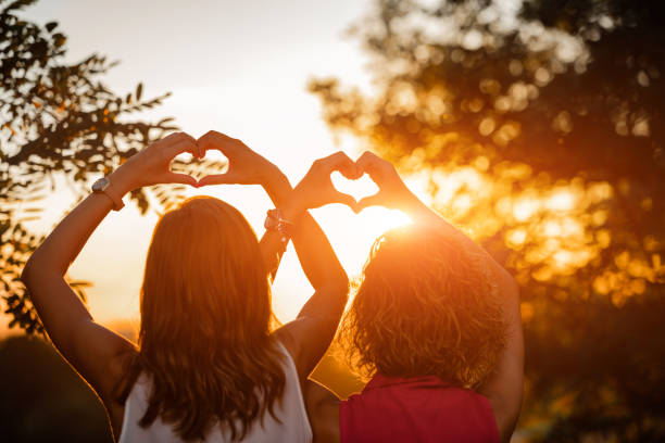 istock Two girls making heart shape symbol with their hands. 1226375994