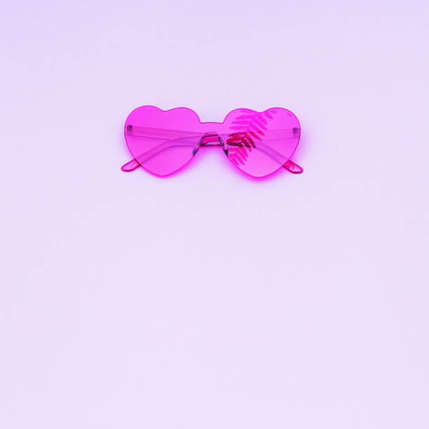 istock Stylish heart shaped glasses with shadow from frond on purple background with copy space. Beautiful trendy red sunglasses. Fashion summer concept. Top view. 1226376320