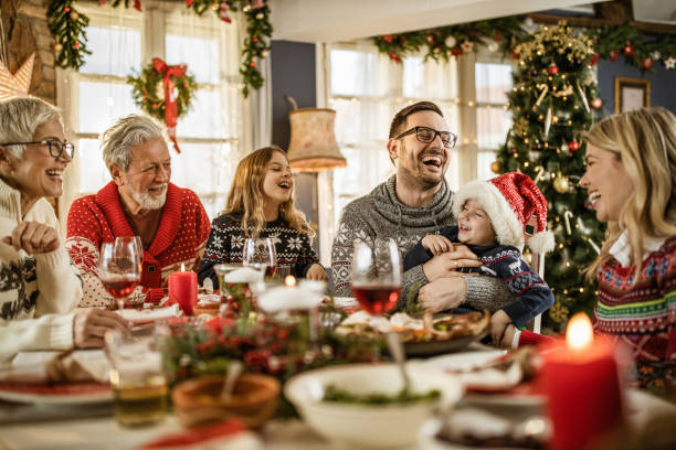 istock Cheerful extended family talking during New Year's meal at dining table. 1226378830