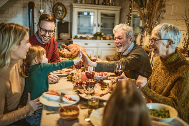 istock Happy multi-generation family communicating while having Thanksgiving lunch in dining room. 1226378970