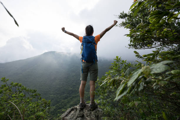 istock Successful hiker feel free at the mountain top cliff edge 1226379007