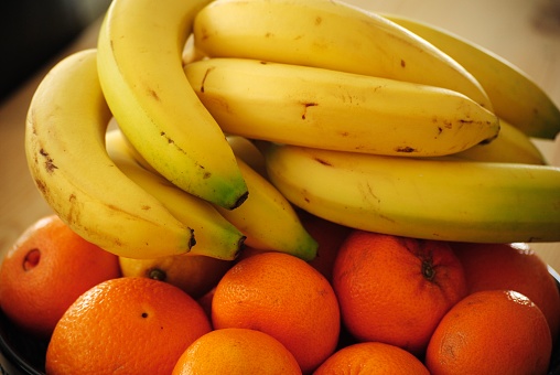 Bananas and oranges in a fruit bowl