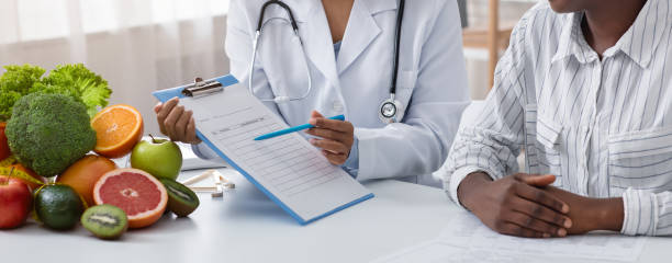 istock Doctor showing patient example of healthy diet 1226380399