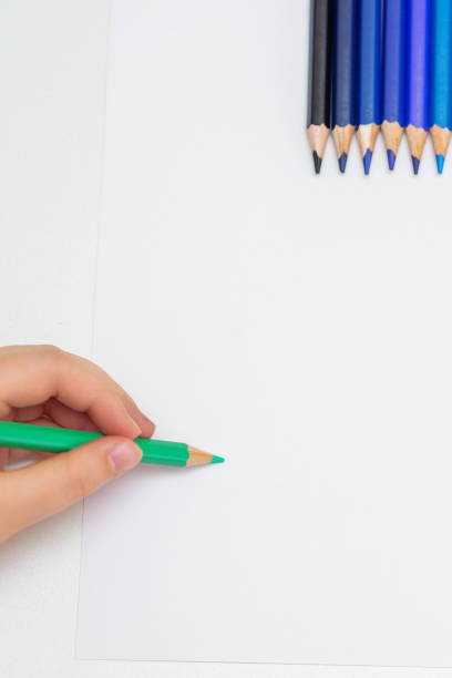 istock Kid is drawing on white blank paper. 1226381564