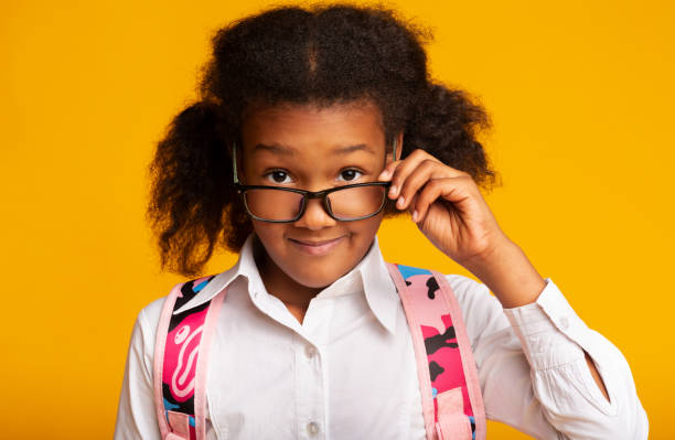 istock Little School Girl Looking At Camera Under Eyeglasses, Studio Shot 1226382842