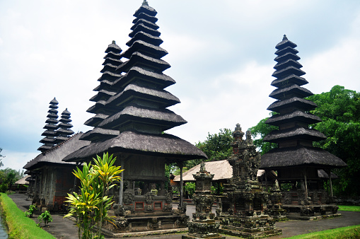 Ancient Meru towers of Pura Besakih temple significant Hindu archaeological site for travelers people travel visit and respect praying at Mount Agung city village in Bali, Indonesia