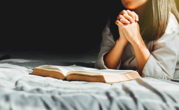 istock young woman worship and pray. 1226384305