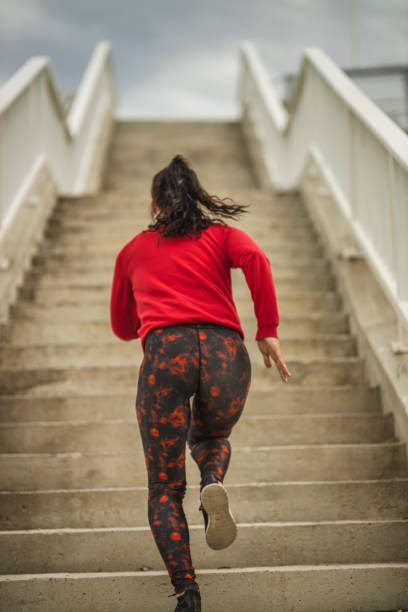 istock Woman running up the stairs 1226385757