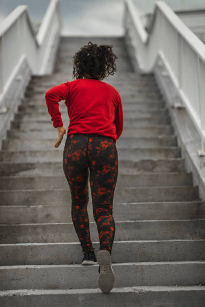 istock Woman running up the stairs 1226385945