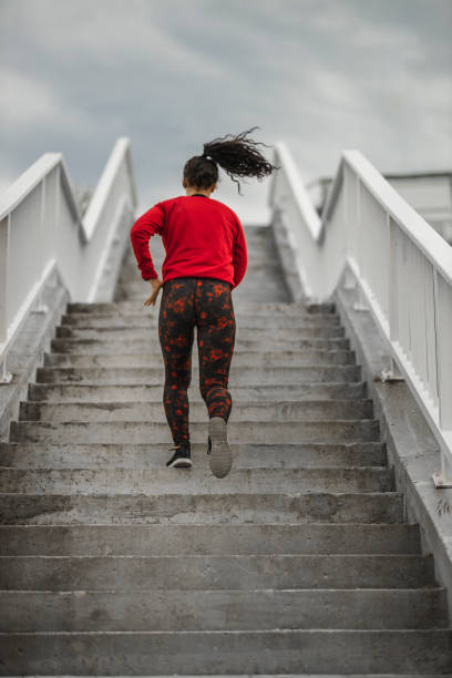 istock Woman running up the stairs 1226386300