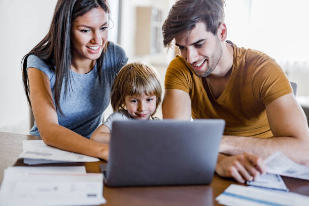 istock Happy family watching something on a computer at home. 1226387379