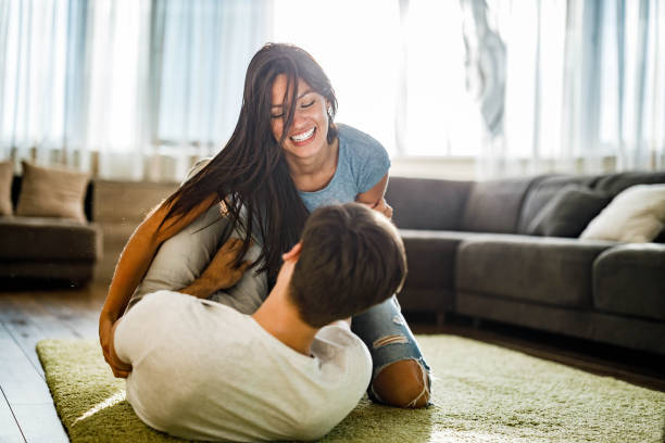 istock Young cheerful couple having fun while playing on caret at home. 1226387722